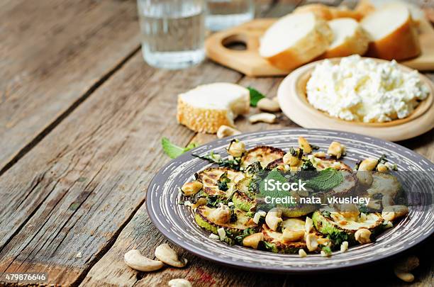 Zucchini Basil Mint Cashews Salad With Ricotta And Fresh Bread Stock Photo - Download Image Now