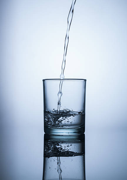 istock Water flows into the glass and makes bubbles 479881186