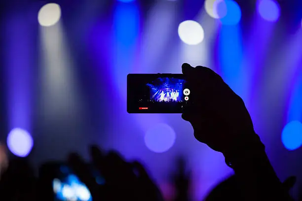 Photo of People at concert shooting video or photo.