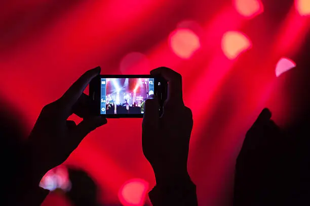 Photo of People at concert shooting video or photo.