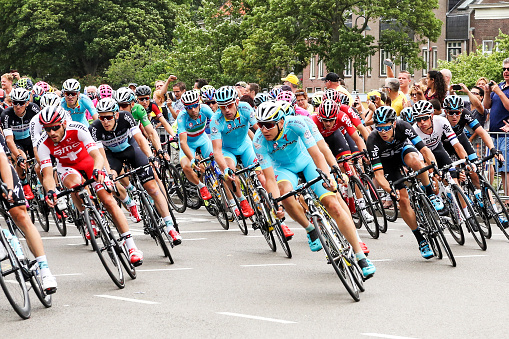 Gouda, The Netherlands – July 5, 2015: People watch the Tour de France peleton riding past Gouda. In 2015 The Netherlands hosted two first stages in  the city of Utrecht; the second day race started in Utrecht and passed through Gouda to the province Zealand. 