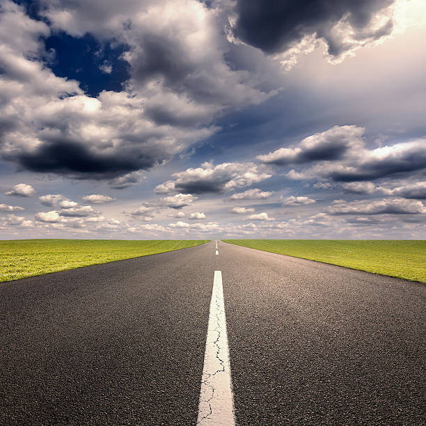 istock Driving ahead on straight road at sunny day 479887316