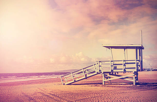 Vintage filtered picture of lifeguard tower, California, USA. Vintage filtered picture of wooden lifeguard tower at sunset, beach in California, USA. santa barbara california photos stock pictures, royalty-free photos & images