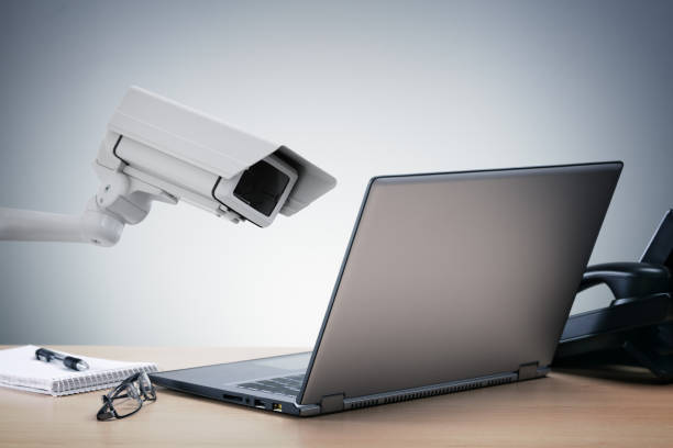 Big brother surveillance Laptop computer being watched in the office by a security camera concept for big brother surveillance or internet computer security eavesdropping stock pictures, royalty-free photos & images