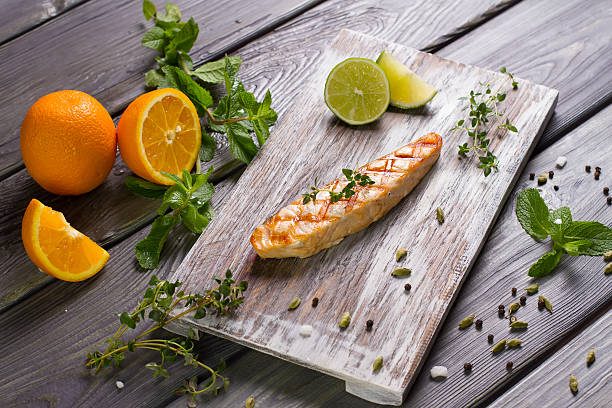 istock Grilled salmon steak with fresh herbs and citrus. 479899996