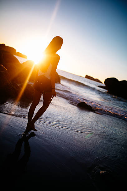 istock Girl walking on beach on a summer evening at sunset 479901002