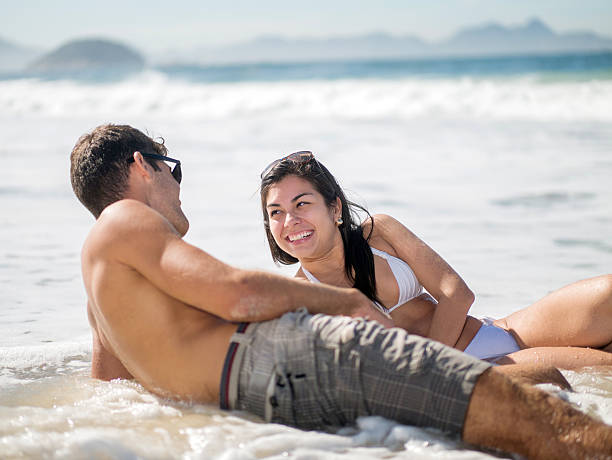 istock Young happy couple communicating while enjoying at the beach. 479903938