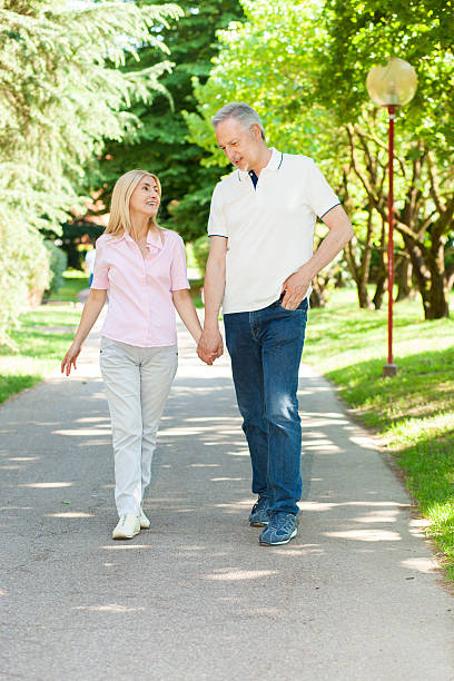 istock Active and happy mature couple walking in the park 479908950