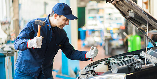 istock Angry mechanic smashing a car engine 479909070