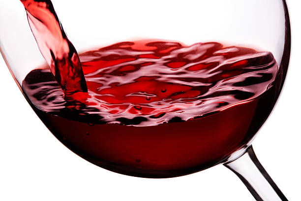 istock Red wine in glass closeup isolated on white 479909096