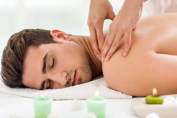 istock Young man relaxing and receiving back massage at spa. 479912712