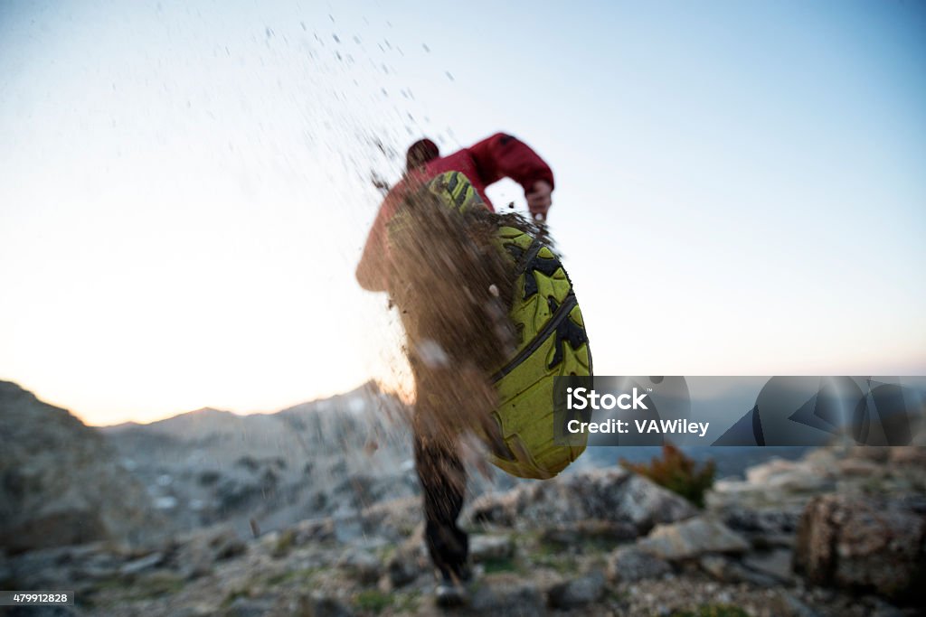 Trail Blazer Fit endurance athlete running in the mountains kicking up dirt from his shoe  Personal Perspective Stock Photo