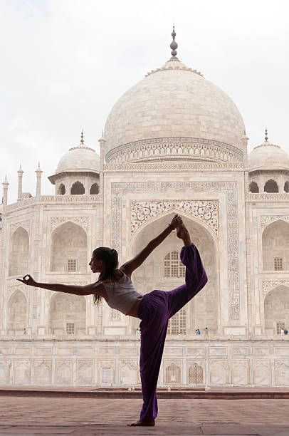 Young female practising yoga pose King Dancer or Natarajasana stock photo