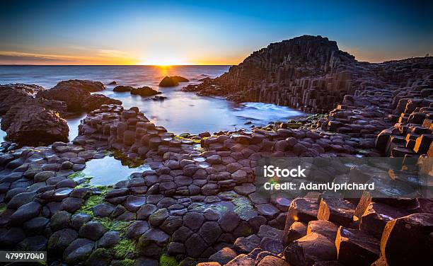 Sunset Over Giants Causeway Northern Ireland Stock Photo - Download Image Now - Giants Causeway, Belfast, Northern Ireland