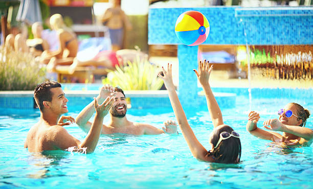 Friends Playing Volleybay In A Pool Stock - Download Image Now - Swimming Pool, - Sport, Volleyball - Ball - iStock