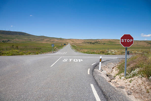 crossroads with stop signal stock photo