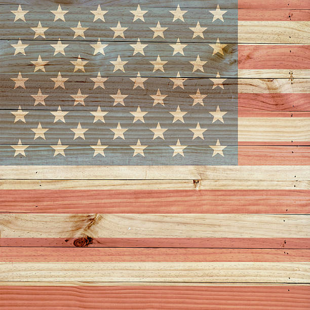 istock American flag on light brown wood background. 479924704