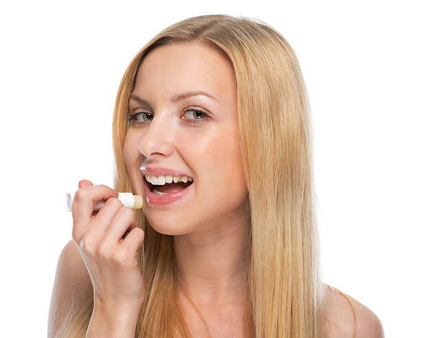 istock young woman using hygienic lipstick 479930731