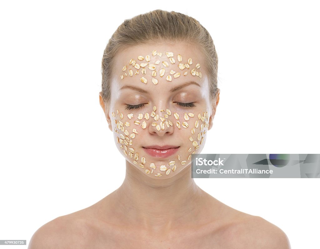 portrait of relaxed young woman making oatmeal mask Portrait of relaxed young woman making oatmeal mask Oats - Food Stock Photo