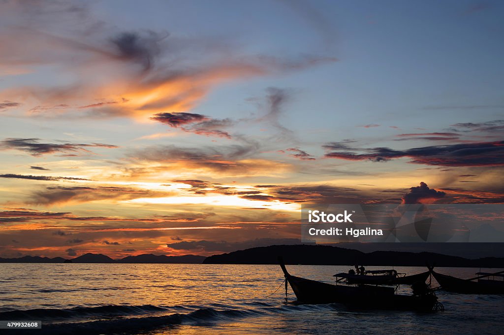 Sunset on Andaman sea, Ao Nang beach, Thailand. Sky landscape, sunset on Andaman sea with silhouette of  rowboats, Ao Nang beach, Thailand.  2015 Stock Photo