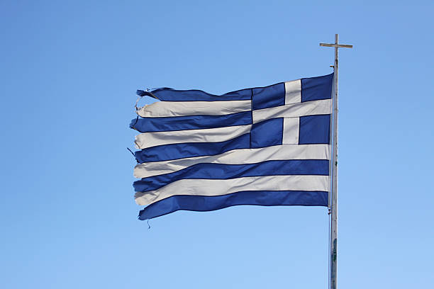 podarty flaga grecji na niebieskim tle - euro symbol crisis time debt zdjęcia i obrazy z banku zdjęć