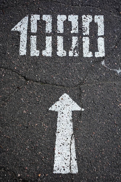 istock White arrow and distance 1000 meters on traffic surface 479935172