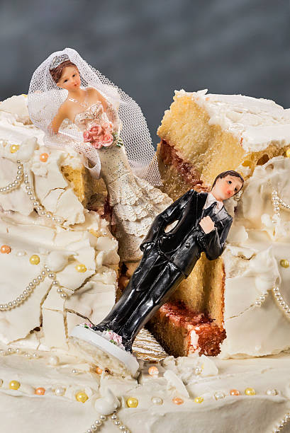 istock Bride and groom figurines collapsed at ruined wedding cake 479936504