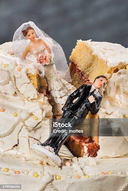 Bride And Groom Figurines Collapsed At Ruined Wedding Cake Stock Photo - Download Image Now