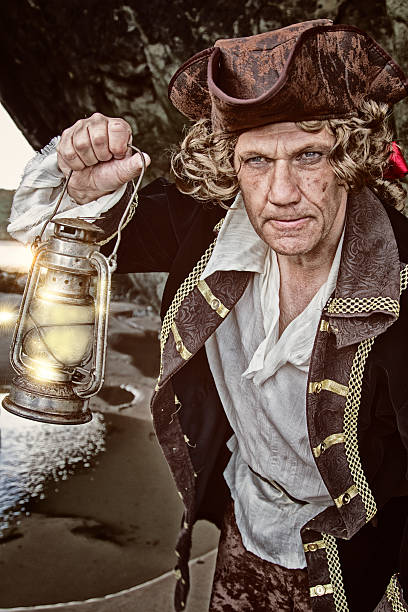 istock Man dressed as a pirate holding a lamp 479940912