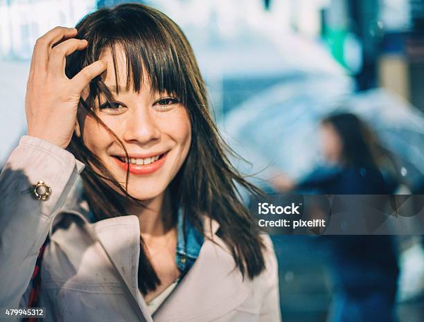 Portrait Of Smiling Japanese Woman Walking Outdoors Stock Photo - Download Image Now