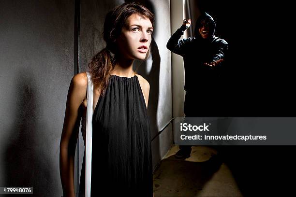 Woman In Danger At A Dark Alley Stock Photo - Download Image Now - 2015, Adult, Aggression