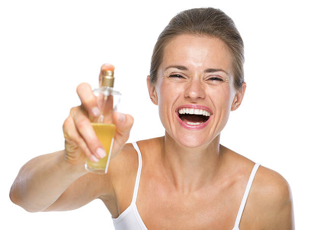 istock happy young woman applying perfume in camera 479951083