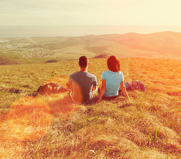 istock Loving couple sitting on meadow at sunny day 479952110