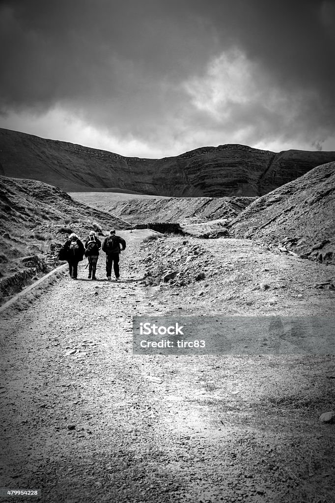 Group of three friends on Welsh countryside hike Mixed group of three friends on Welsh countryside photography hike in the Brecon Beacons 2015 Stock Photo