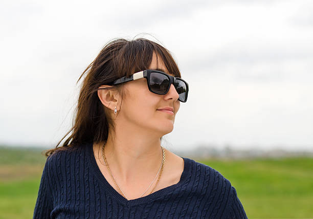 istock Woman standing looking out over the countryside 479954492