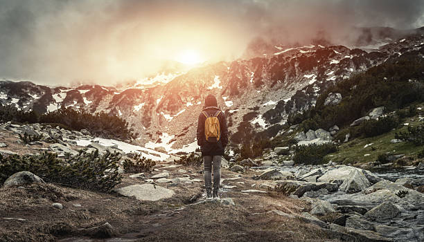 istock Traveler with backpack walking in mountains at sunset 479958502