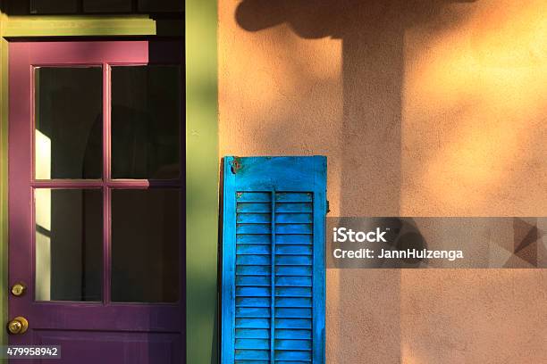 Santa Fe Style Porch With Colorful Door Shutter Adobe Wall Stock Photo - Download Image Now