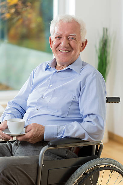 istock Happy man on wheelchair drinking coffee 479964796