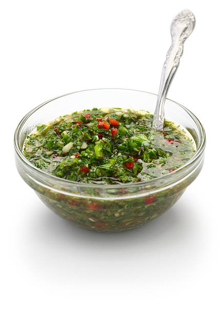 chimichurri sauce, traditional Argentine condiment chimichurri is made from finely chopped parsley, minced garlic, olive oil, oregano, and wine vinegar. chimichurri stock pictures, royalty-free photos & images