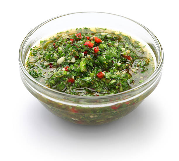 chimichurri sauce, traditional Argentine condiment chimichurri is made from finely chopped parsley, minced garlic, olive oil, oregano, and wine vinegar. chimichurri stock pictures, royalty-free photos & images