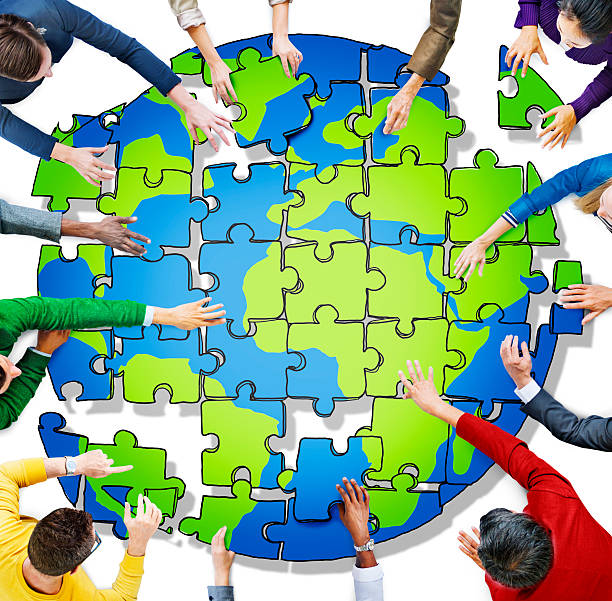 istock People with Jigsaw Puzzle Forming Globe in Photo and Illustratio 479965348