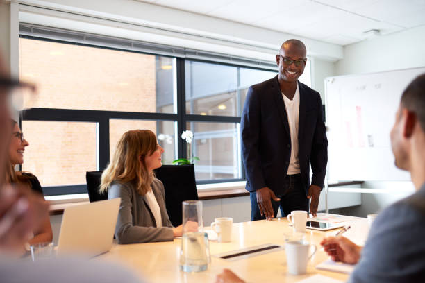 istock Black male executive standing and leading a work meeting 479966030