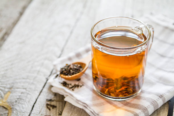 istock Black tea in glass cup, sugar, rustic wood background 479966532
