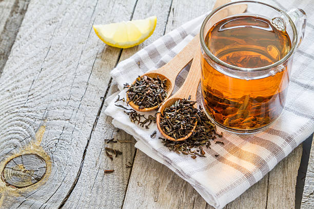 istock Dry black tea in wood spoon, rustic wood background 479966546