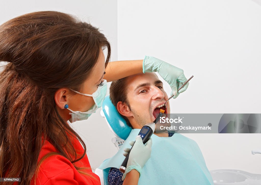 Dental filling The dentist is filling the patient's tooth 2015 Stock Photo