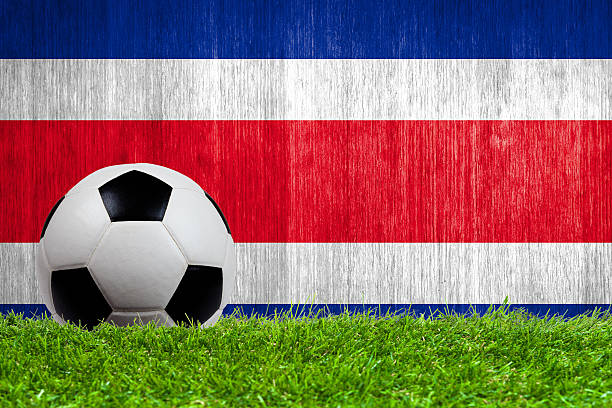 soccer ball on grass with costa rica flag background - galizischer fußballverband 個照片及圖片檔