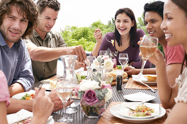 istock Friends Enjoying Dinner Party Outdoors 479971157