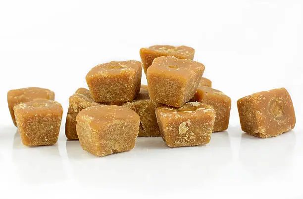 Stacking coconut flower sugar blocks on white background.