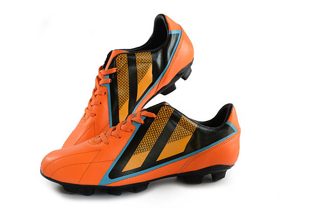 Football boots orange on white background