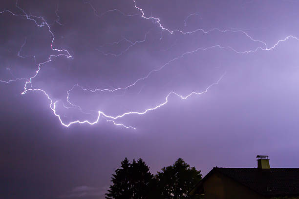 istock Lightnings in blue sky with a house and a tree 479981294